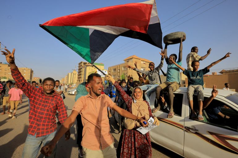Protesters march during a rally marking the anniversary of the April uprising, in Khartoum, Sudan.