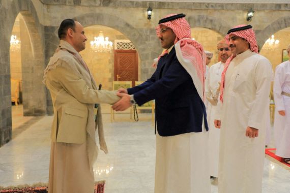 The head of the Houthi Supreme Political Council, Mahdi al-Mashat, shakes hands with Saudi ambassador to Yemen Mohammed Al-Jaber at the Republican Palace in Sanaa, Yemen