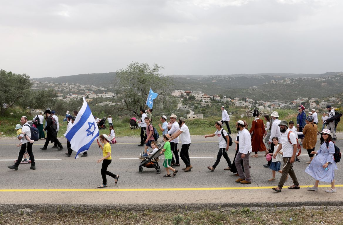 Israeli settlers hold a protest march