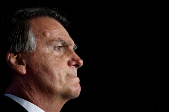 Ex-President Jair Bolsonaro purses his lips while watching a "Power of The People" event hosted by Turning Point USA