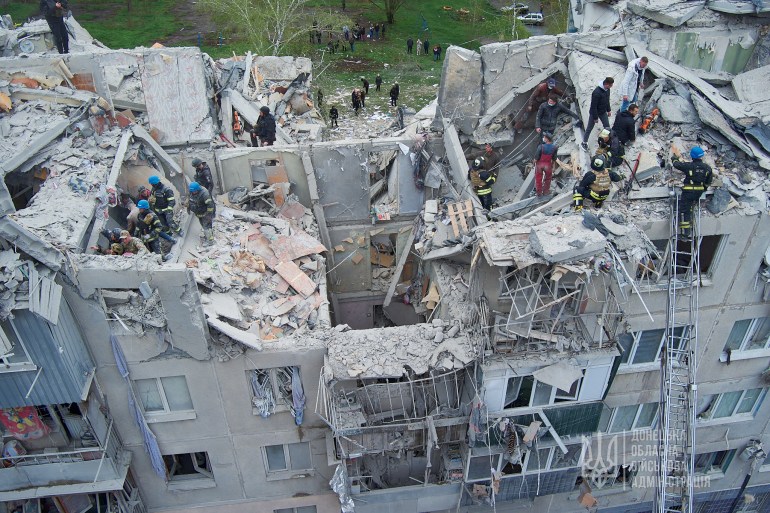 Rescuers work at a site of a residential building damaged by a Russian military strike, amid Russia's attack on Ukraine, in Sloviansk, Donetsk region, Ukraine April 14, 2023. Press service of the Donetsk Regional Military-Civil Administration/Handout via REUTERS ATTENTION EDITORS - THIS IMAGE HAS BEEN SUPPLIED BY A THIRD PARTY. MANDATORY CREDIT. DO NOT OBSCURE LOGO. NO RESALES. NO ARCHIVE.