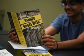 Umer Siddiqui, 18, holds a pamphlet as he and a group of students discuss the “The Bluest Eye” during a meeting for their book club, which reads and discusses books that have been banned in various Texas school districts, at the University Branch Library in Sugar Land, Texas, U.S. April 15, 2023. REUTERS/Callaghan O'Hare