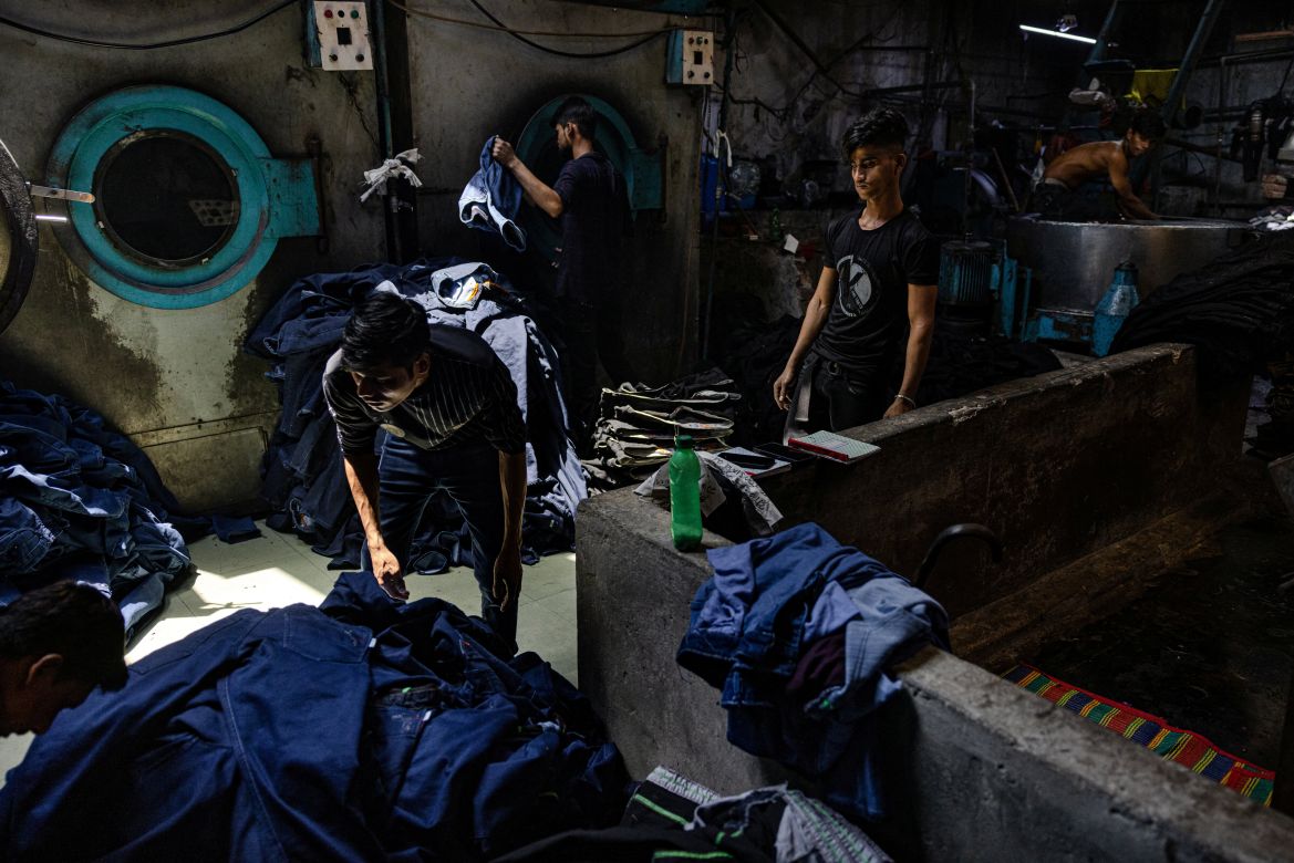 Employees work inside a factory that washes and dyes textiles in Dhaka
