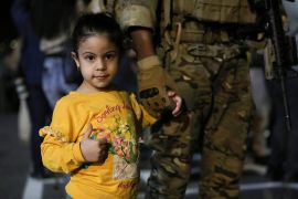 A child looks on as Jordanian citizens and other nationals who were evacuated from Sudan, arrive at Marka Military Airport, in Amman