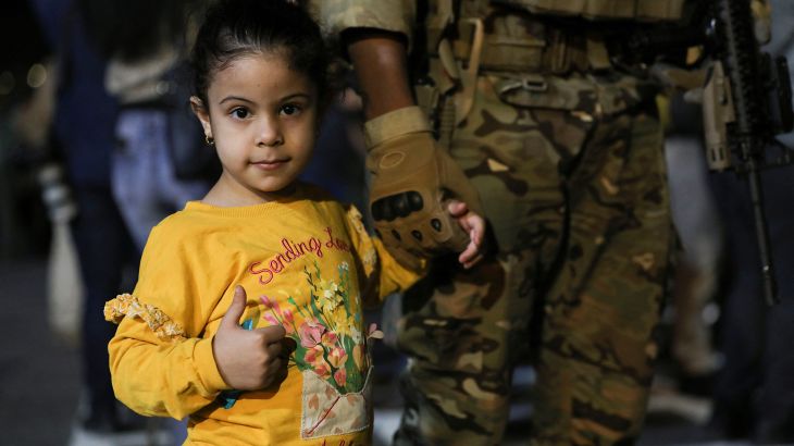 A child looks on as Jordanian citizens and other nationals who were evacuated from Sudan, arrive at Marka Military Airport, in Amman