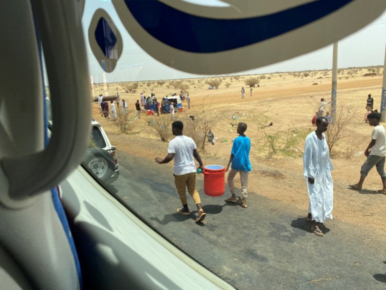 People carry kerkade (hibiscus) juice and cold water to distribute them to people amid evacuations from Khartoum to Port Sudan April 23, 2023 in this picture obtained from social media. Twitter@dalliasd/via REUTERS THIS IMAGE HAS BEEN SUPPLIED BY A THIRD PARTY. MANDATORY CREDIT.