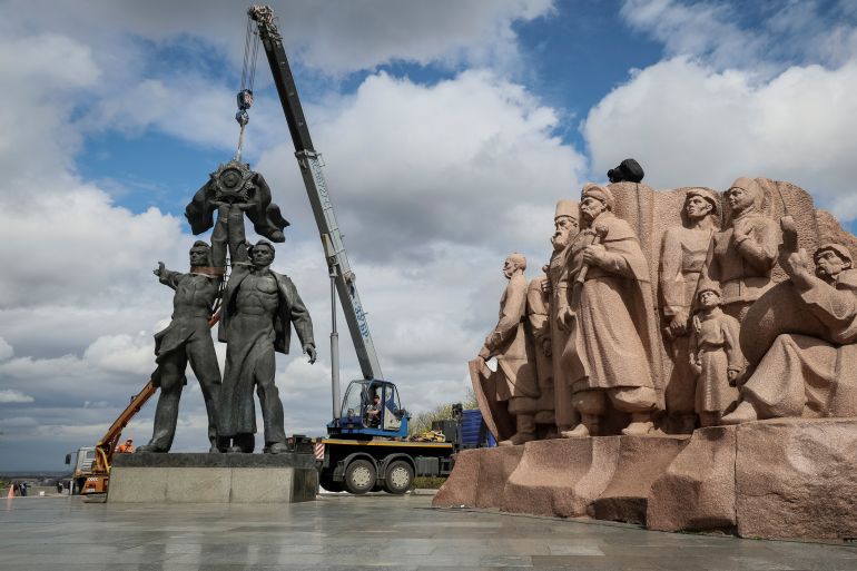 A Soviet monument to a friendship between Ukrainian and Russian nations is seen during its demolition