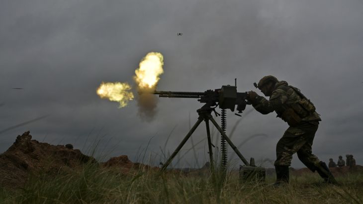 A Ukrainian service member fires a DShK machine gun during military drills at a training ground, amid Russia's attack on Ukraine, in Zaporizhzhia region, Ukraine April 28, 2023. REUTERS/Stringer