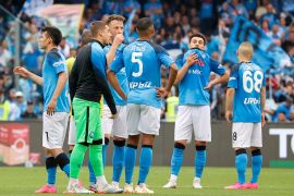 Napoli's players stand and look dejected after the match