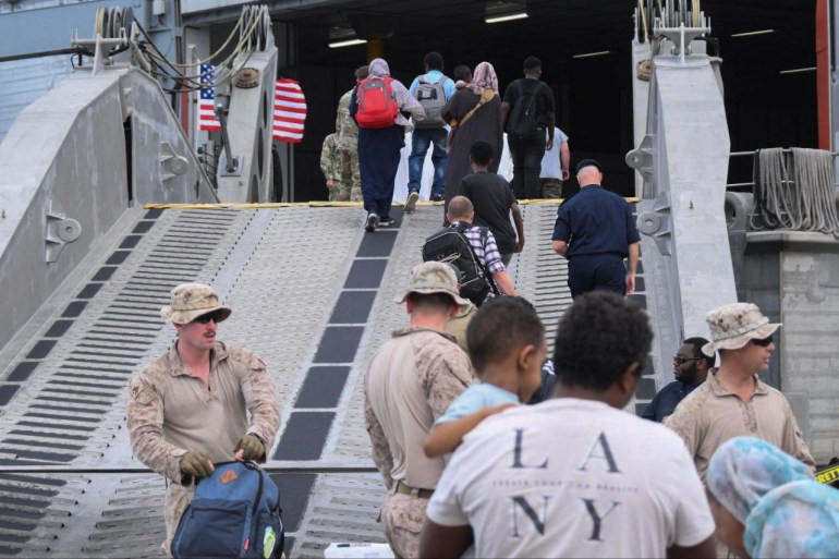 American nationals board a US Navy ship, while they are evacuated from Port Sudan, Sudan.