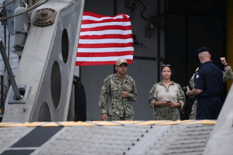 Members of the U.S. military look on, while American nationals are evacuated from Sudan.