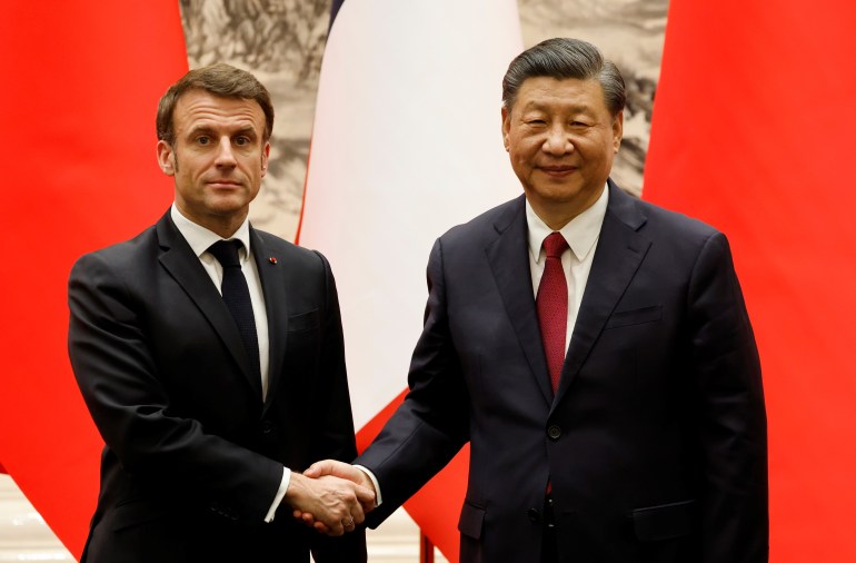 Chinas President Xi Jinping shakes hands with French President Emmanuel Macron