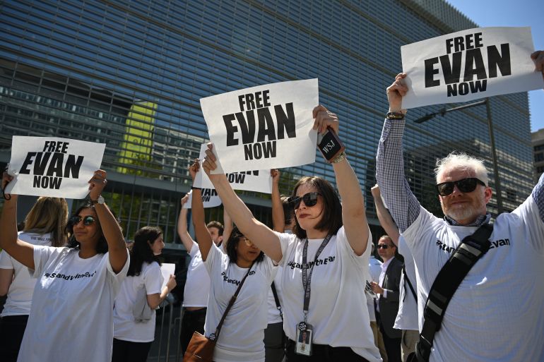 Journalists hold "free Evan" signs