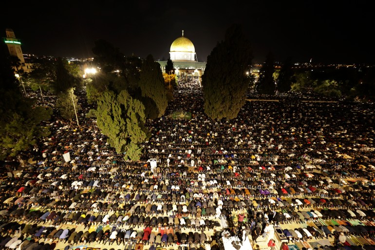 Tens of thousands Muslim worshippers pray near the Dome of the Rock