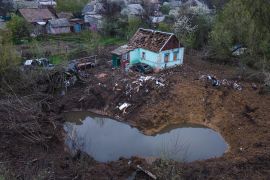 A bird's eye view of a partially destroyed house and crater after missile raids in the town of Kostyantynivka, Donetsk region, Ukraine.