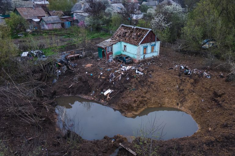 A bird's eye view of a partially destroyed house and crater after missile raids in the town of Kostyantynivka, Donetsk region, Ukraine.