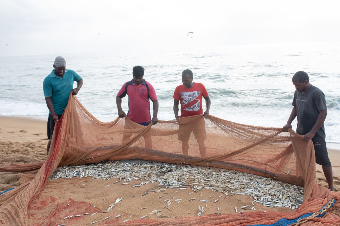 A photo of people holding a fishing net.