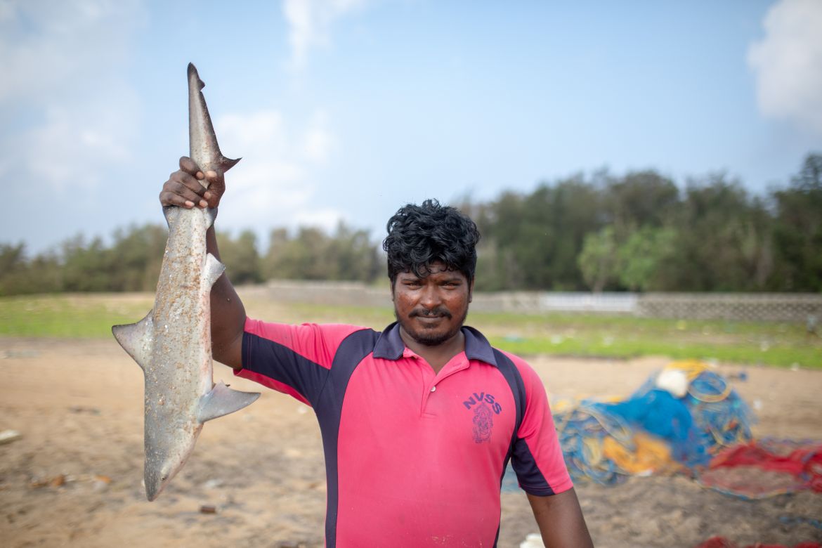 A photo of a person holding up a fish.