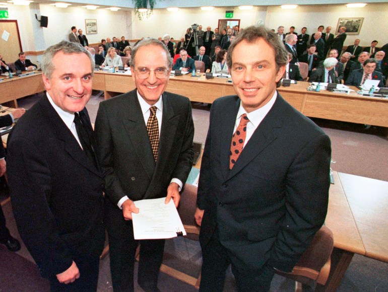 FILE- In this file photo dated Friday, April 10, 1998, posing together after signing the Good Friday Agreement, with right to left, British Prime Minister Tony Blair, U.S. Sen. George Mitchell, and Irish Prime Minister Bertie Ahern, after they signed the agreement for peace in Northern Ireland. Many of the central architects gathered in Northern Ireland Tuesday April 10, 2018, to mark its 20th anniversary of the Good Friday Agreement peace accord which ended three decades of sectarian violence. (AP Photo)