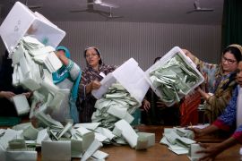 Pakistani election staff empty the ballot boxes to start counting following polls closed at a polling station for the parliamentary elections in Islamabad, Pakistan