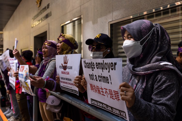 Domestic workers protest in support of better working conditions. They are carrying placards against the so-called 'Two-week rule'