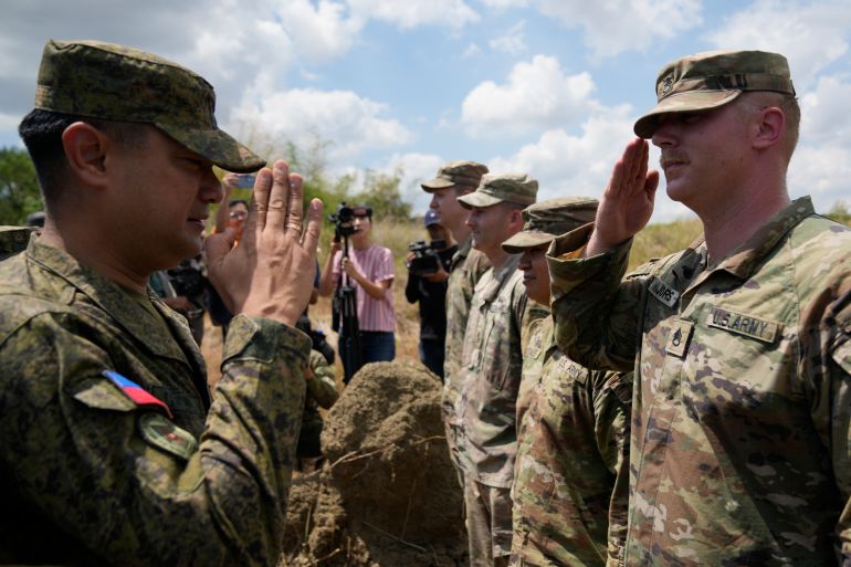 Troops from the Philippines and the US salute one another at the beginning of military exercises on March 31