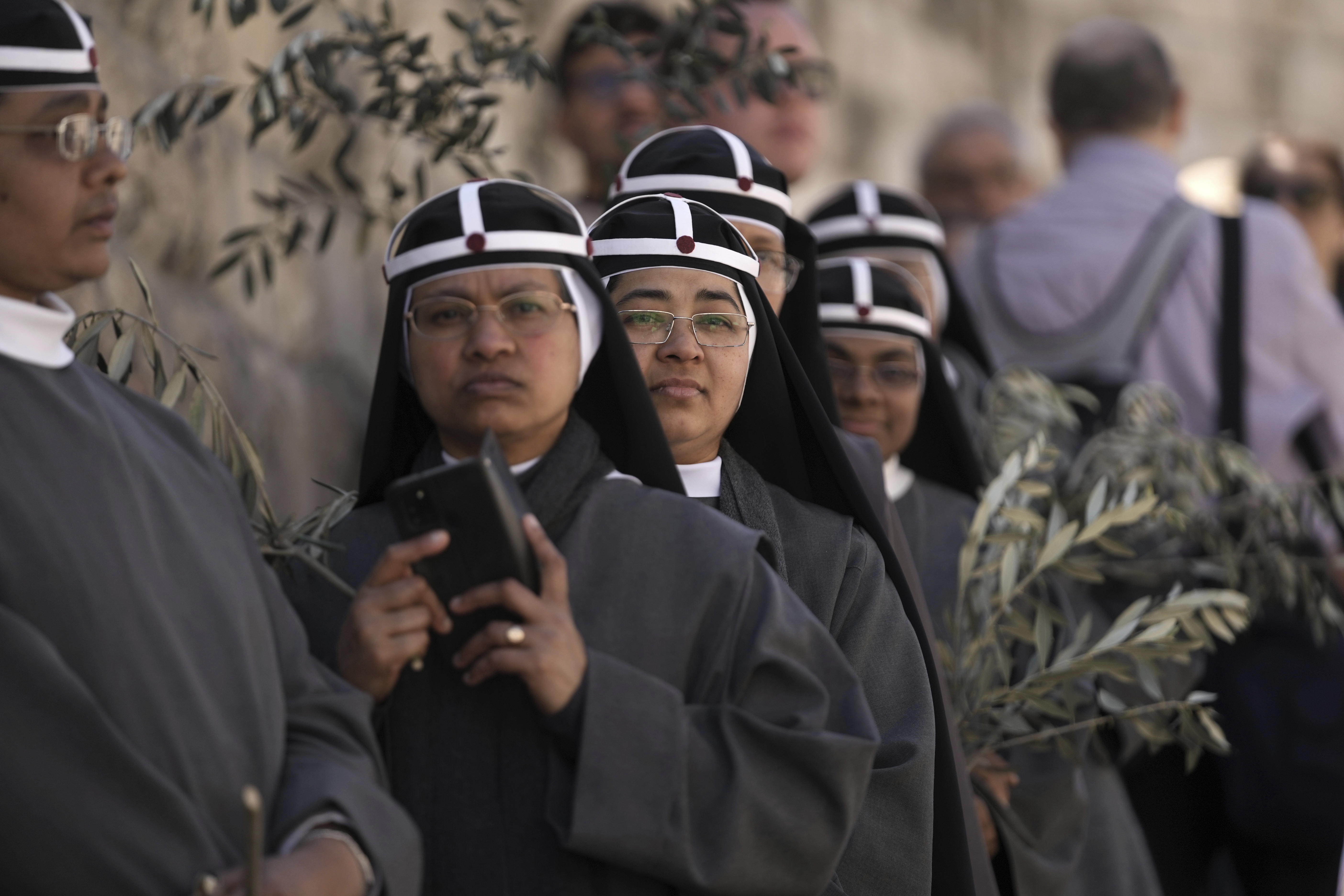 Nuns take part in the Palm Sunday procession on the Mount of Olives