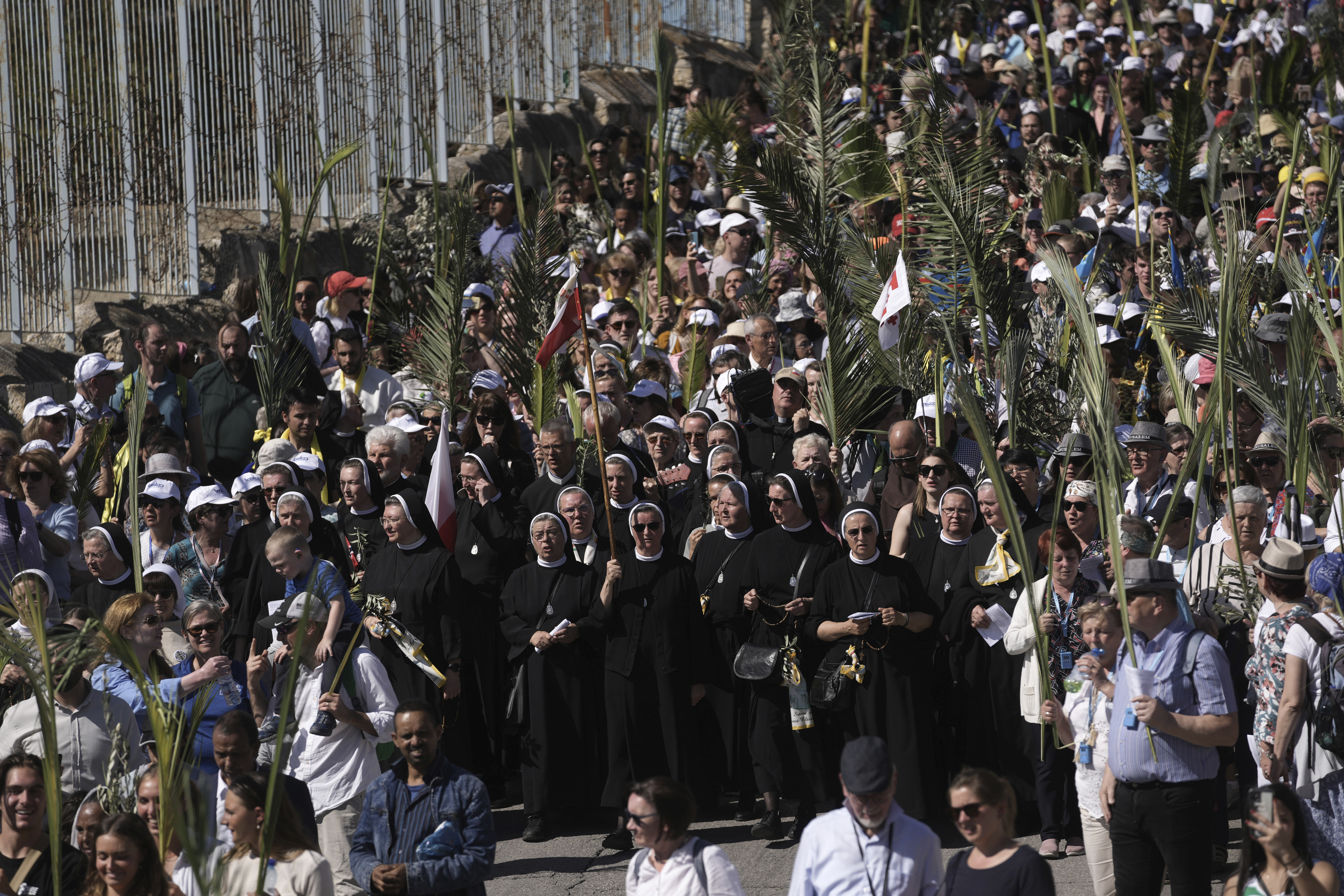 Christians walk in the Palm Sunday procession on the Mount of Olives