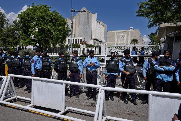 Police officers stand guard outside the Supreme Court to ensure security, in Islamabad, Pakistan, Tuesday, April 4, 2023.