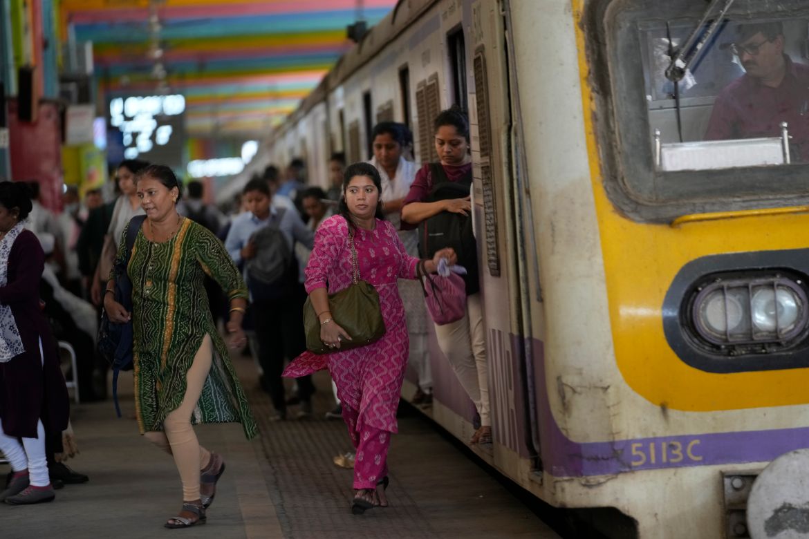 Women rush out of a train during peak hours at Churchgate station in Mumbai
