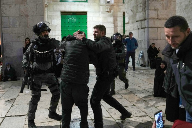 Israeli police detain a Palestinian worshipper at the Al-Aqsa Mosque compound in the Old City of Jerusalem during the Muslim holy month of Ramadan, Wednesday, April 5, 2023. Palestinian media reported police attacked Palestinian worshippers, raising fears of wider tension as Islamic and Jewish holidays overlap.(AP Photo/Mahmoud Illean)