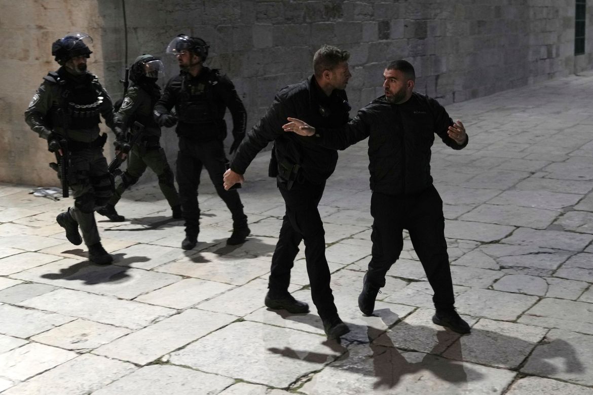 A Palestinian worshipper is led away by Israeli police at the Al-Aqsa Mosque compound