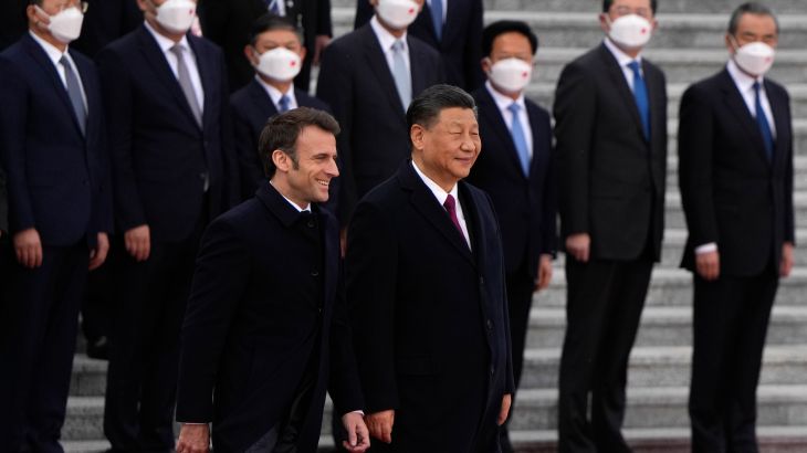 French President Emmanuel Macron, bottom left, walks with Chinese President Xi Jinping during a welcome ceremony held outside the Great Hall of the People in Beijing