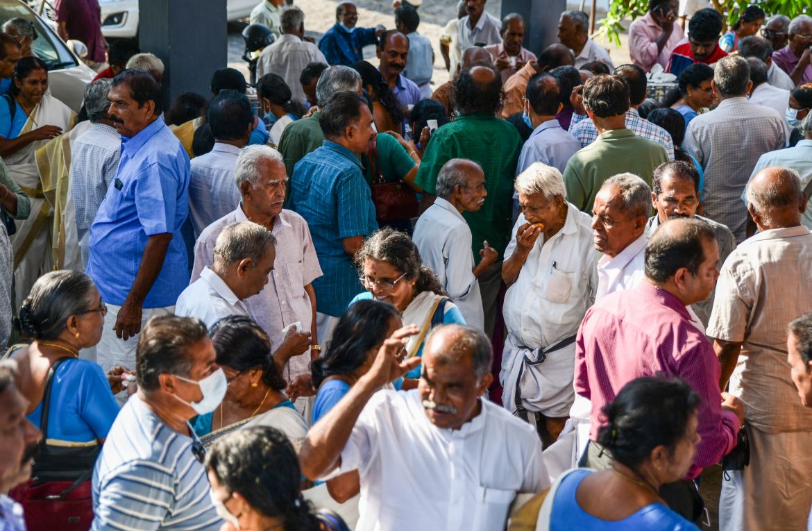Pensioners chat as hundreds of them gather for a meeting in Piravom, Kerala state,