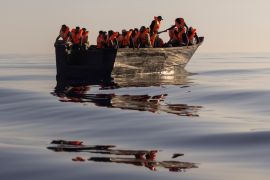 Migrants with life jackets provided by volunteers of the Ocean Viking, a migrant search and rescue ship run by NGOs SOS Mediterranee and the International Federation of Red Cross (IFCR), sail in a wooden boat as they are being rescued some 26 nautical miles south of the Italian Lampedusa island in the Mediterranean sea.