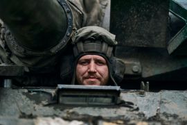 A Ukrainian soldier looking out of a tank on the front line in Bakhmut, Ukraine.