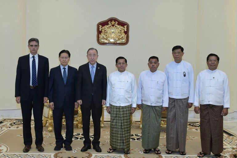Former UN chief Ban Ki-moon and Senior General Min Aung Hlaing stand with their officials following their meeting in Naypyidaw. Ban and his two officials are in suits on the left. Min Aung Hlaing and his three officials in traditional Burmese dress on the right. It's a formal photograph.