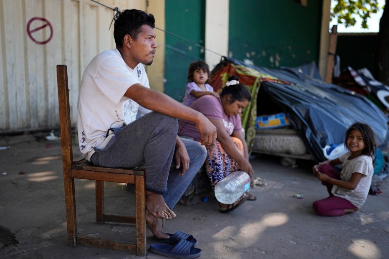 Ava Guarani Indigenous husband and wife, Juan Domingo and Vilma, from Canindeyu, camp out with their daughters near the National Indigenous Office (INDI) to demand food aid in Asuncion, Paraguay, Friday, April 28, 2023. Paraguay's general elections are set for April 30. (AP Photo/Jorge Saenz)