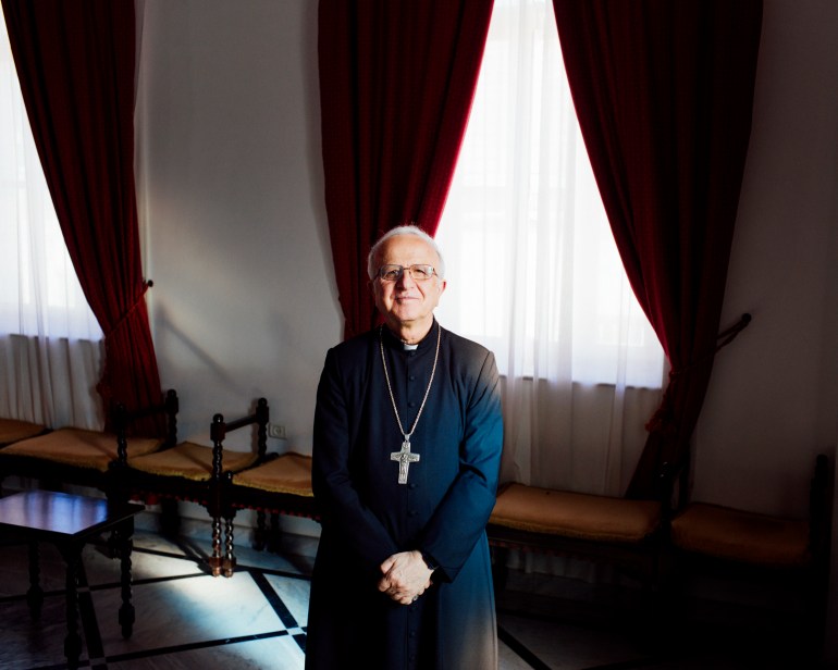 Bishop Shomali standing in his office