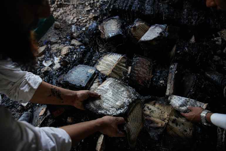 Mohammad Shahbuddin Sifting Quran from piles of burnt book at seminary in Nalanda Bihar