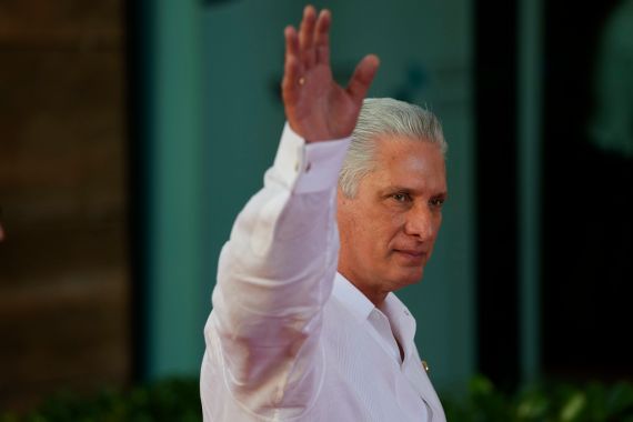 Cuban President Miguel Diaz-Canel waves to onlookers