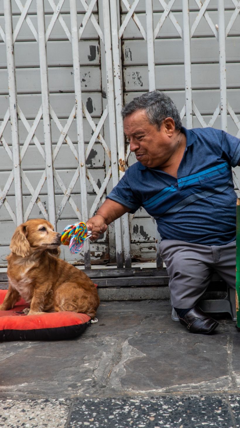 A street vendor in Peru, with his dog