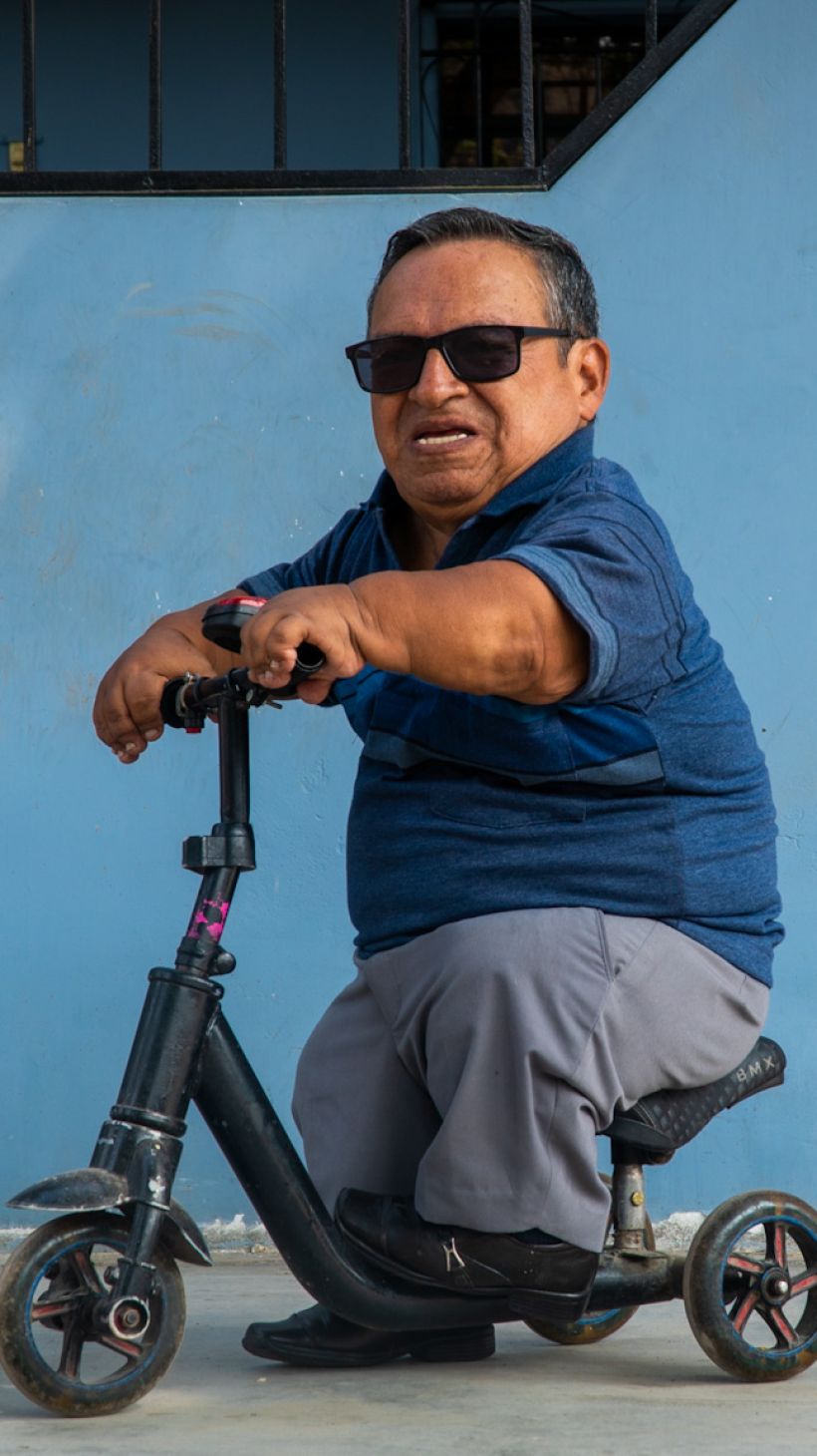 A man rides a scooter in Lima, Peru