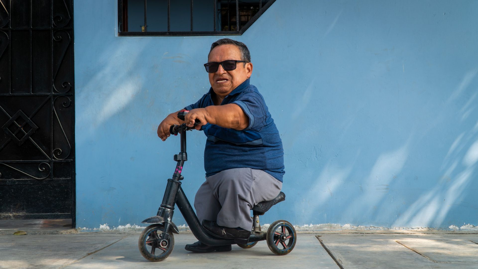 A man rides a scooter in Lima, Peru