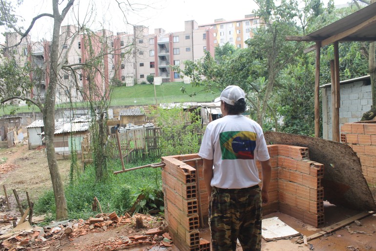 A community leader observes a destroyed community kitchen