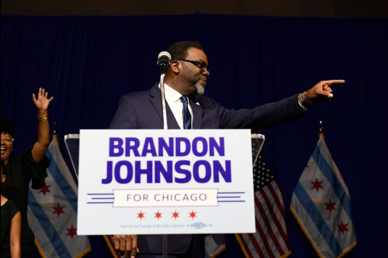 Brandon Johnson points to supporters on election night