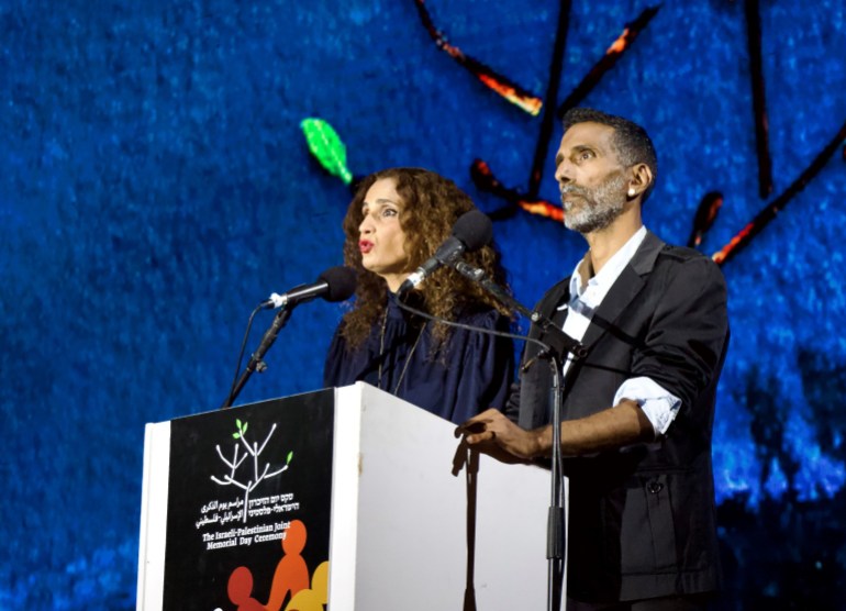 Raida Adon, left, and Yossi Zabari, right, on the stage