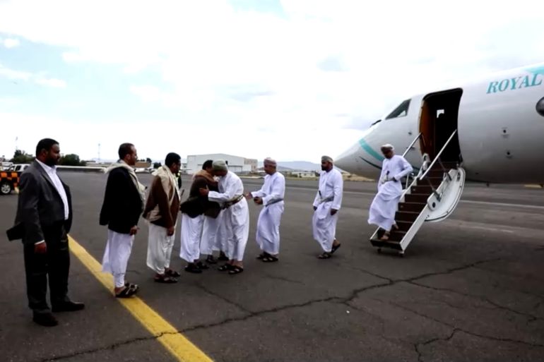 Omani delegates walking down the steps of plane