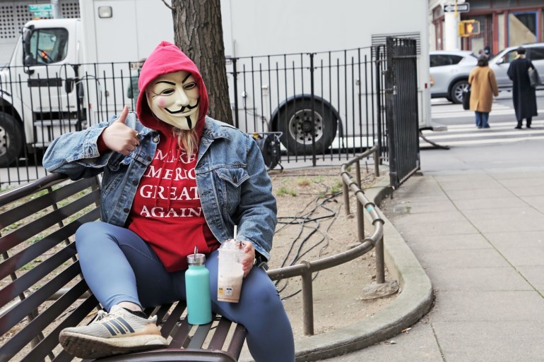 Peggy Sue, 41, sporting a Guy Fawkes mask outside Manhattan Criminal Court