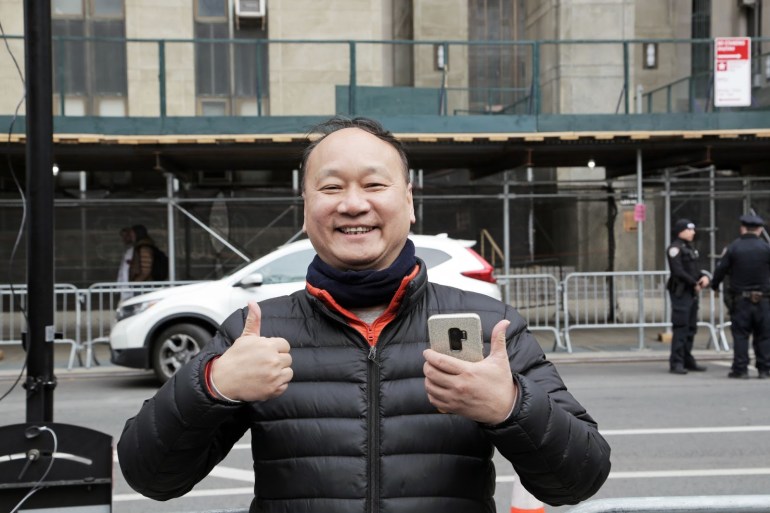 Maxwell Lau, a 62-year-old Chinatown business owner became gleeful upon seeing the swarms of tourists, police officers and reporters who had assembled outside the courthouse hours before Trump’s court appearance. [Dorian Geiger/Al Jazeera]